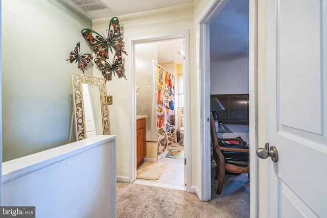 hall featuring light colored carpet