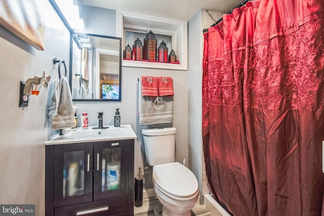 bathroom featuring curtained shower, toilet, and vanity