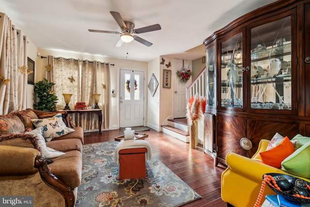 living room featuring ceiling fan and dark hardwood / wood-style flooring