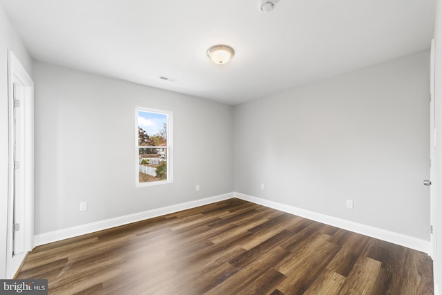 empty room featuring dark wood-type flooring