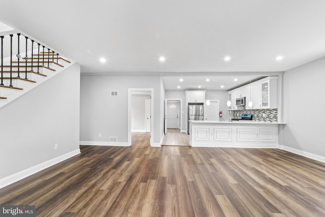 unfurnished living room featuring dark hardwood / wood-style floors