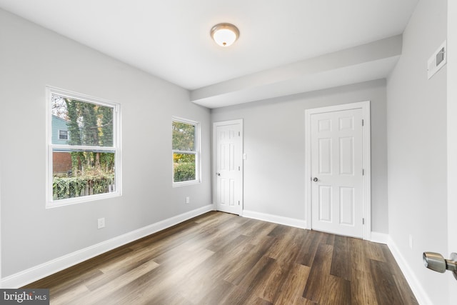 unfurnished bedroom featuring dark hardwood / wood-style floors