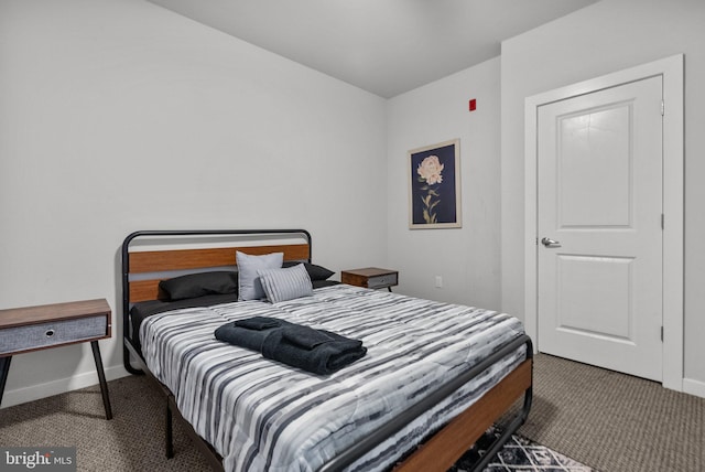 bedroom with dark colored carpet