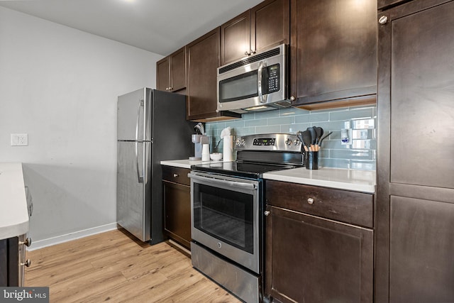 kitchen with tasteful backsplash, dark brown cabinetry, light hardwood / wood-style flooring, and appliances with stainless steel finishes