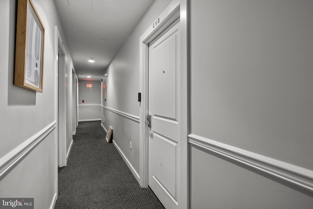 corridor with dark colored carpet