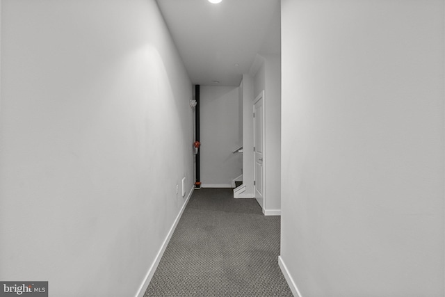 corridor featuring dark carpet