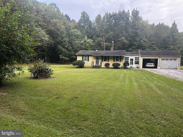 ranch-style house featuring a garage and a front lawn