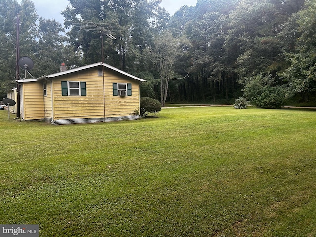 view of side of home with a lawn