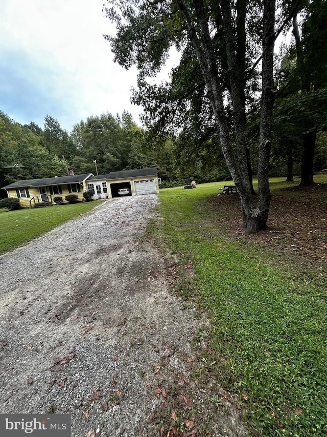 view of front of property with a garage and a front yard