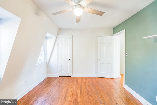 bonus room with light hardwood / wood-style flooring and ceiling fan