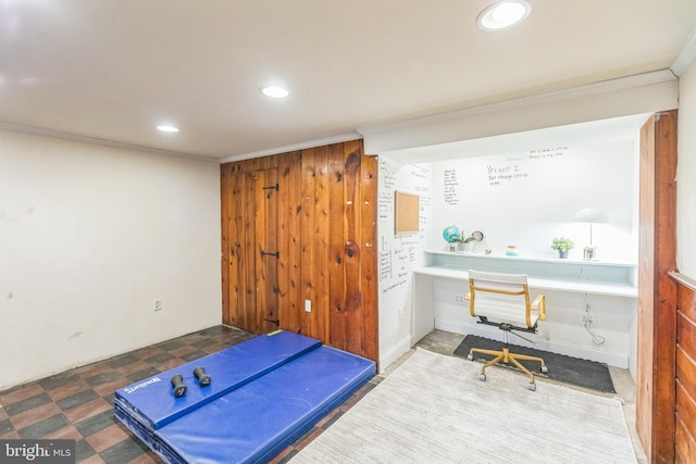 workout area featuring crown molding