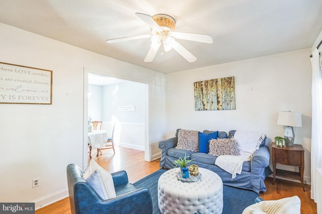 living room featuring hardwood / wood-style floors and ceiling fan