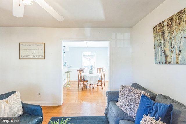 living room with hardwood / wood-style floors and ceiling fan