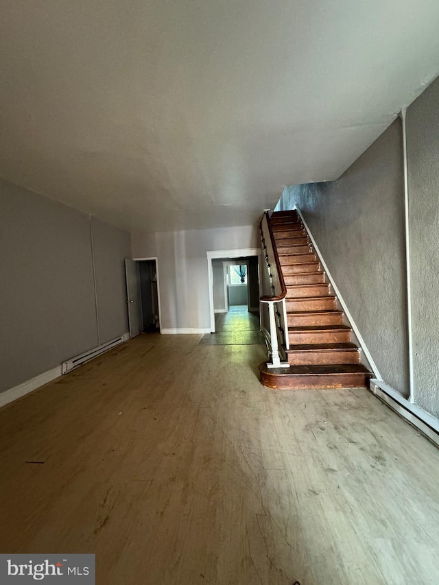 interior space with wood-type flooring and a baseboard radiator