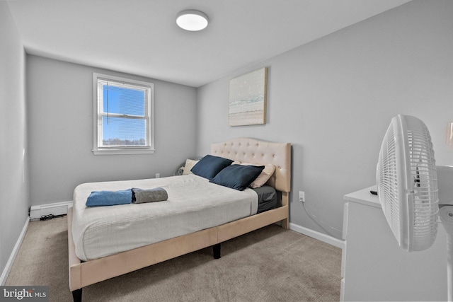 bedroom with light colored carpet and a baseboard heating unit