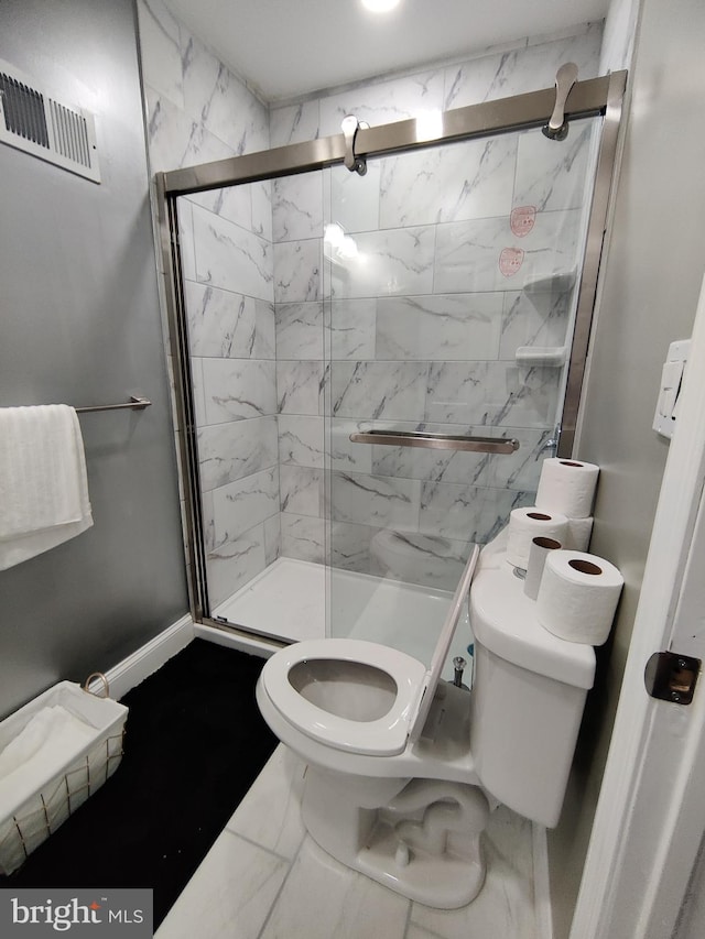 bathroom featuring walk in shower and toilet