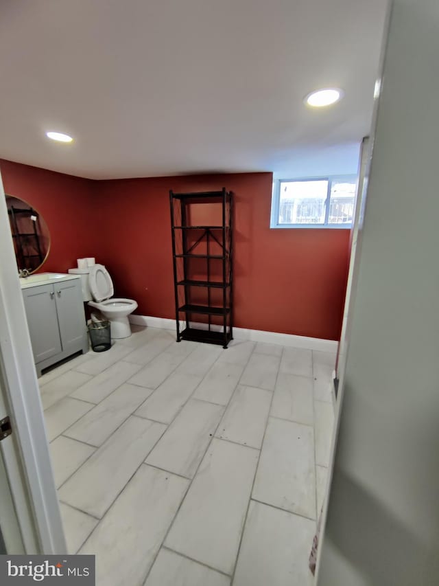 bathroom featuring vanity and toilet