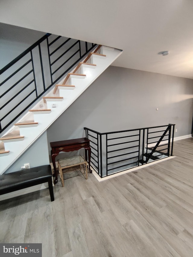 stairs with hardwood / wood-style flooring