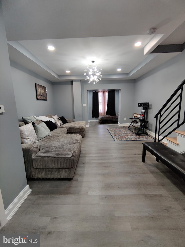 living room with hardwood / wood-style floors and an inviting chandelier