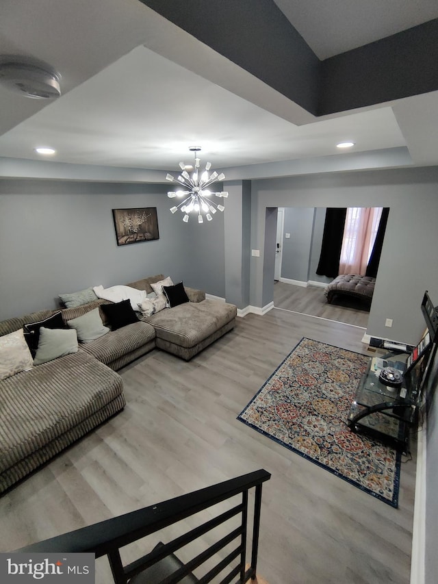 living room featuring light wood-type flooring and a chandelier