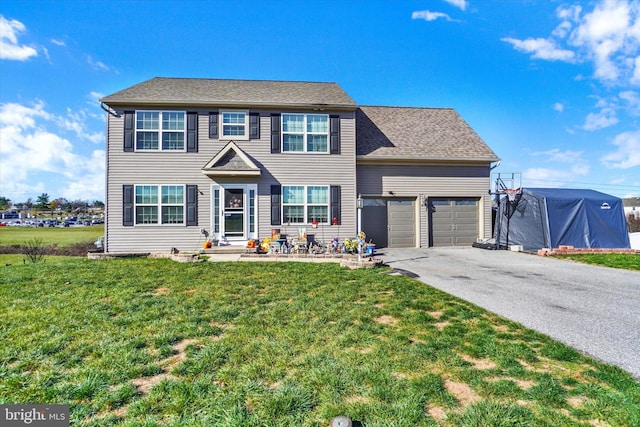 view of front of home with driveway, an attached garage, a shingled roof, and a front yard