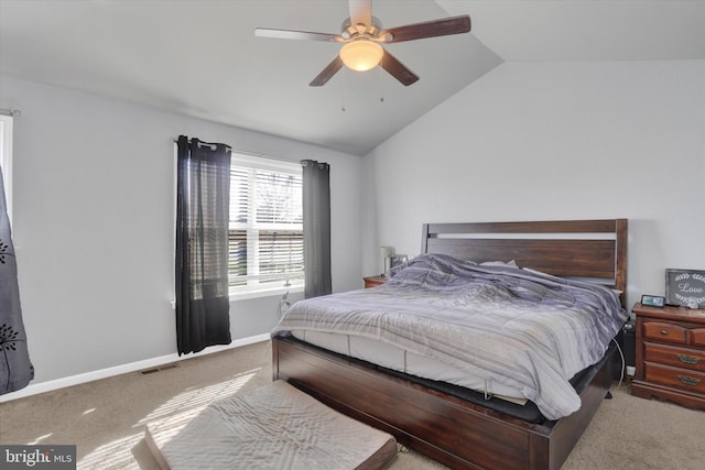 bedroom with ceiling fan, lofted ceiling, and carpet flooring