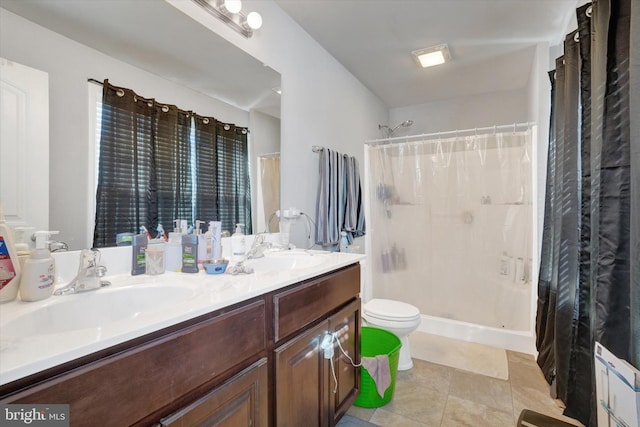 bathroom featuring tile patterned floors, toilet, vanity, and walk in shower