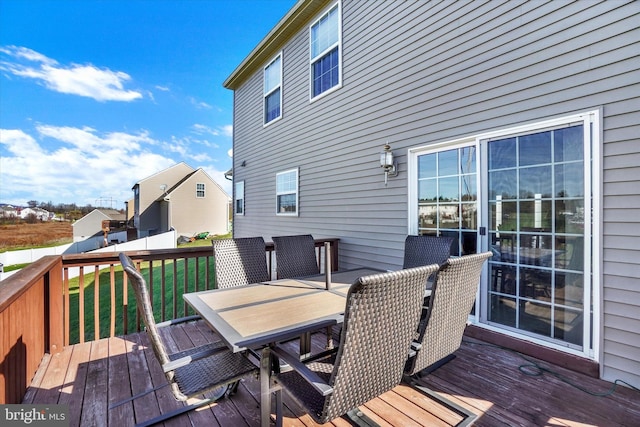 wooden terrace featuring a yard