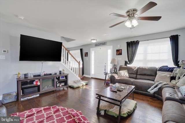 living room with ceiling fan and dark hardwood / wood-style floors