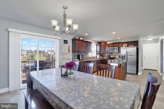 dining area featuring a notable chandelier and light tile patterned flooring