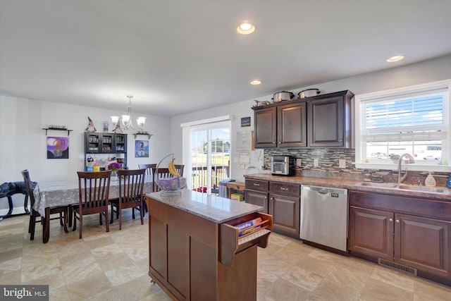 kitchen with sink, hanging light fixtures, a notable chandelier, dishwasher, and dark brown cabinetry