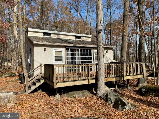 back of property with a wooden deck