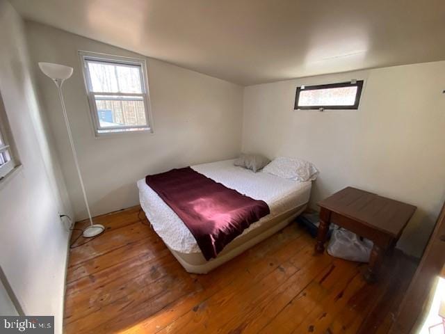 bedroom with hardwood / wood-style flooring and vaulted ceiling