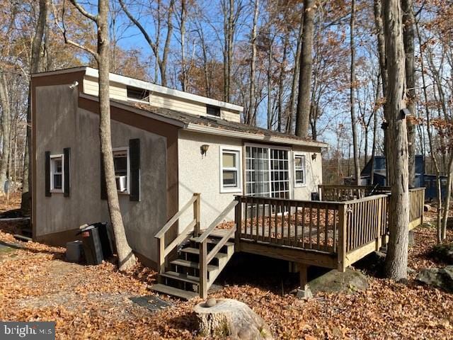 back of house featuring a wooden deck