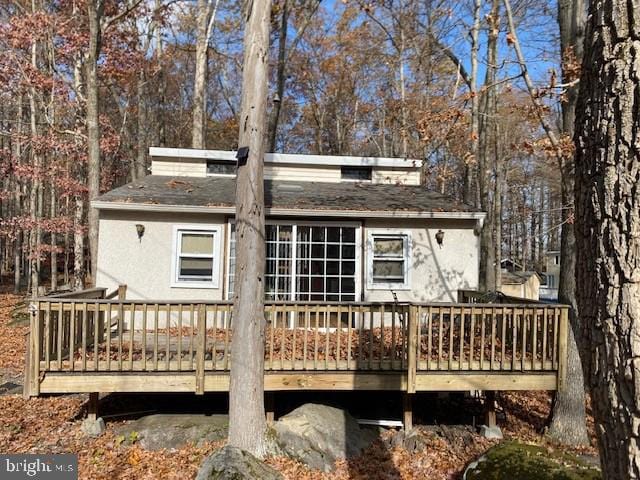 rear view of house with a wooden deck