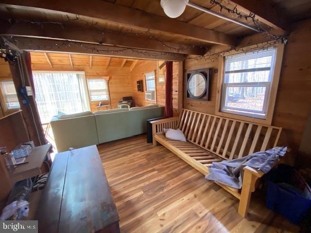 misc room featuring wood walls, hardwood / wood-style flooring, wooden ceiling, and beam ceiling