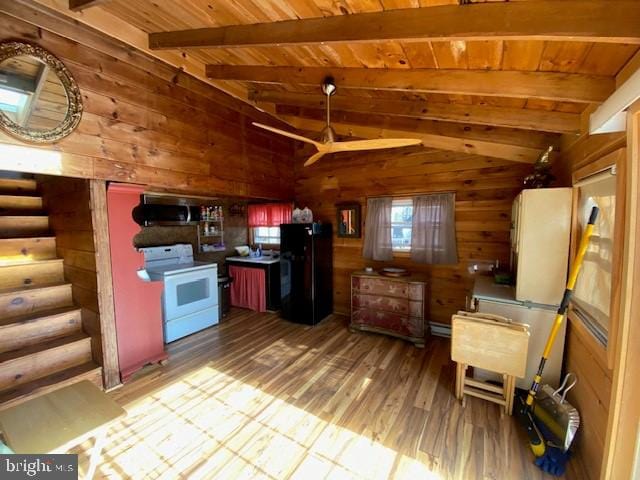 kitchen with black fridge, vaulted ceiling with beams, white range, hardwood / wood-style floors, and wooden ceiling