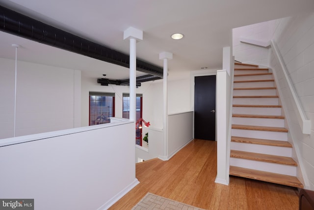 stairway with hardwood / wood-style floors