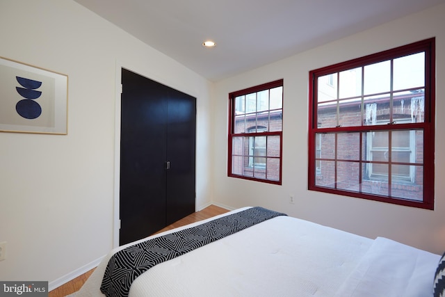 bedroom featuring hardwood / wood-style floors and a closet