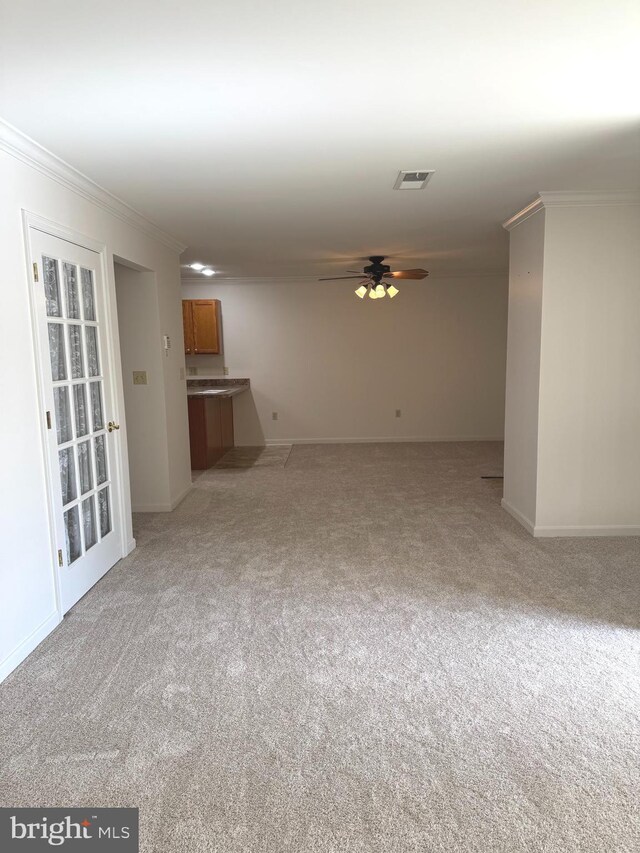 357 Winners Cir, Red Lion, PA 17356 - unfurnished living room with light carpet, ceiling fan, crown molding, and baseboards