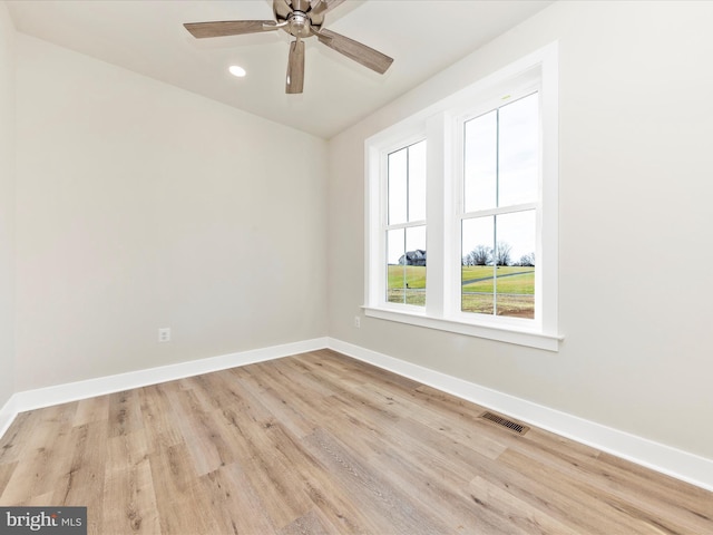 spare room featuring ceiling fan and light wood-type flooring