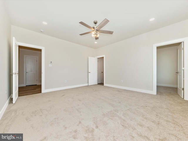 unfurnished bedroom with ceiling fan and light carpet