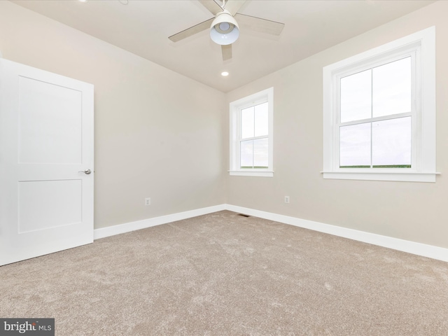 carpeted empty room with ceiling fan