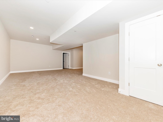 basement featuring light carpet