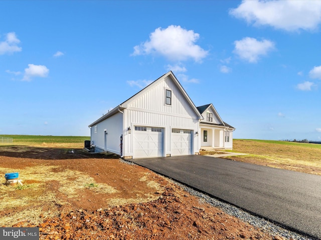 view of front of home featuring a rural view and a garage