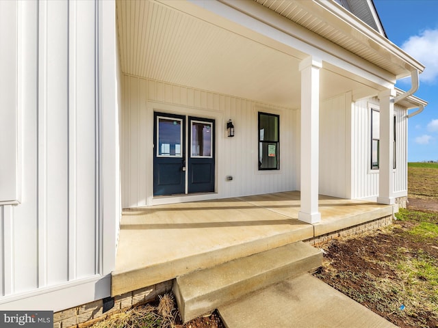 view of exterior entry featuring a porch