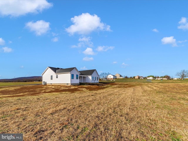 view of yard with a rural view