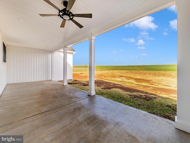 view of patio featuring ceiling fan and a rural view