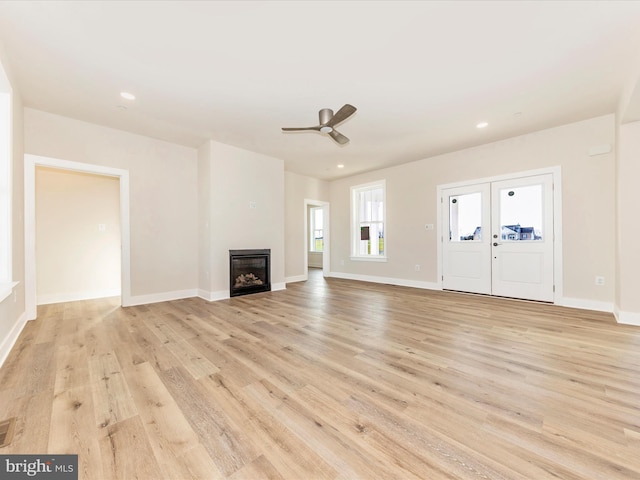 unfurnished living room with ceiling fan and light hardwood / wood-style floors