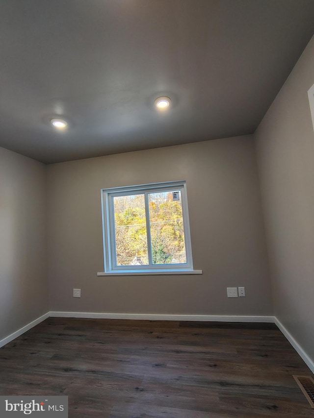 spare room featuring dark hardwood / wood-style flooring